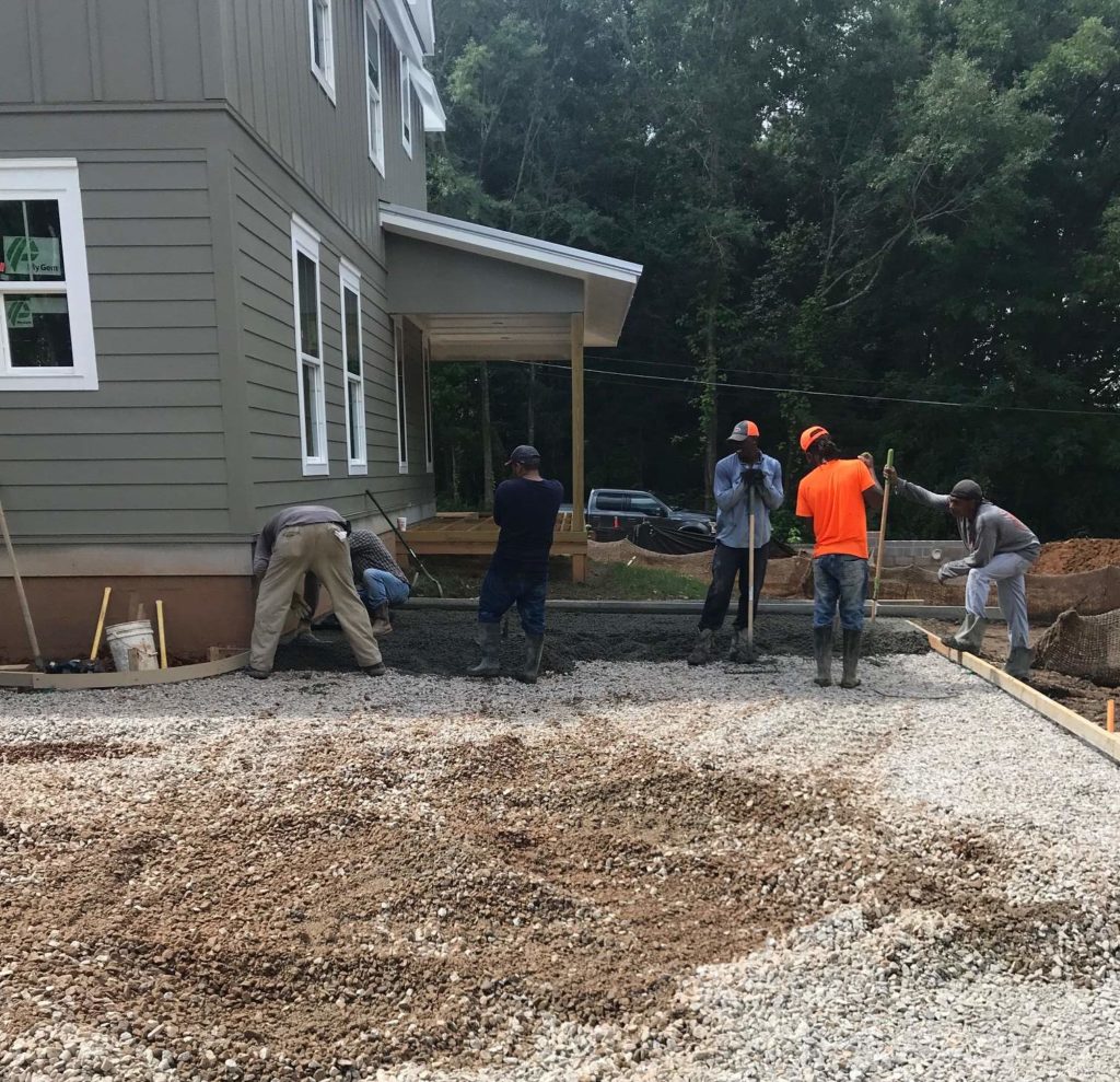 Workers making sure the pervious is laid just right at a local Auburn Student Housing project.